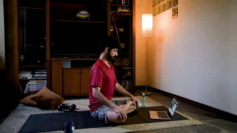 Man performing meditation through video classes Stock Footage 130609627