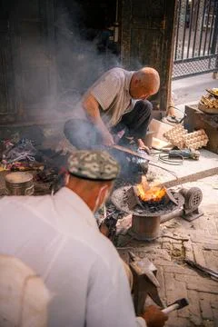 A man performing a metal work burning metal in Kashgar Ancient City Stock Photos