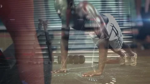 Man performing plank exercise in gym, with animated network graphics Stock Footage 328587130