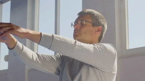 Man performing slow tai chi movements while sitting on floor Stock-Footage 197594463
