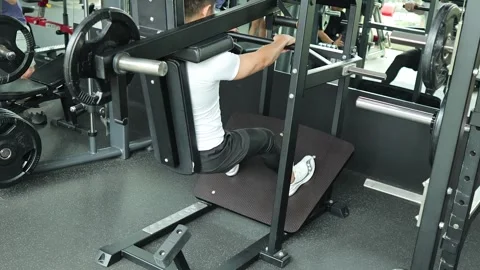 Man Performing Squats on Machine in Bangkok Gym 스톡 동영상 326849428