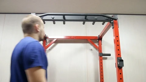 Man performing strength exercise for upper-body on pull up bar at gym 動画素材 122922161