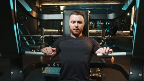 The man is performing a strength training gesture in the gym Stock Footage 274507494