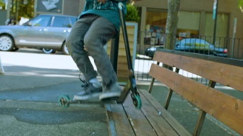 Man performing stunt with push scooter on street Stock Footage 87804837