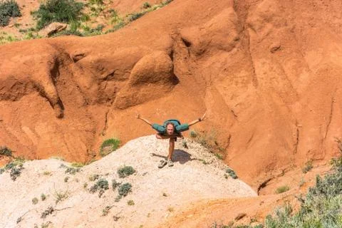 A man performs the asanas in the mountains canyon Fairy Tale, Kyrkyzstan. Stock Photos