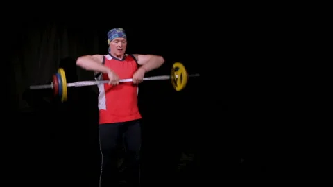A man performs a barbell upright rowing.Floor phase. Stock Footage 133756318