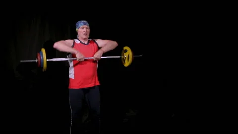 A man performs a barbell upright rowing.Slow speed. Stock Footage 132952222