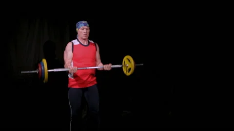 A man performs a Bicep curls with a barbell.Slow speed. Stock Footage 132952262