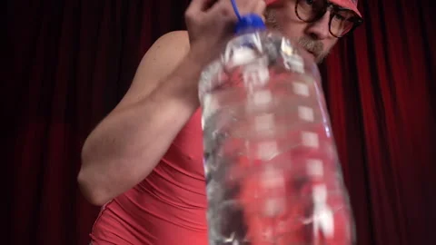 Man performs Bicep curls using a large bottle of water as a weight. Stock Footage 133111632