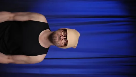 Man performs Bicep curls using two large bottles of water as a weight. Stock Footage 135292537