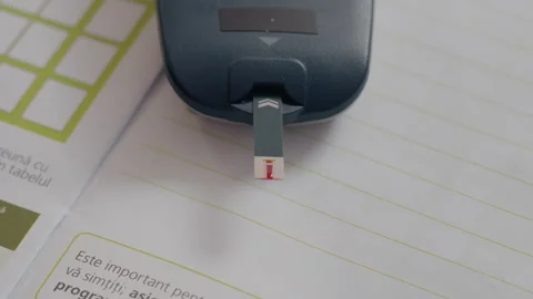 Man performs blood sugar test with glucometer while monitoring health Stock Footage 302429739