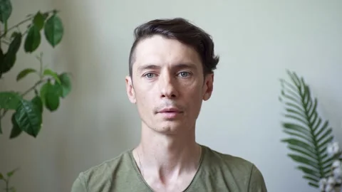 A man performs breathing practice sitting in a calm environment in a room Stock Footage 277876384