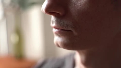 A man performs breathing practice sitting in a calm environment in a room Stock Footage 277876451