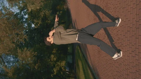 A Man Performs Choreography With His Hands At Sunset In The Park 4k Video Stock Footage 275347713