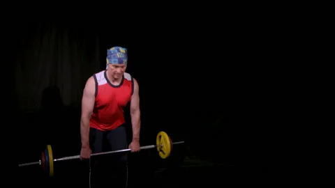 A man performs a deadlift with a barbell.Copy space. Stock Footage 132952203