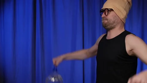 Man performs delta exercise using two large bottles of water as a weight. Stock Footage 134914753