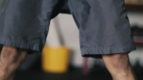 Man performs dynamic weight ball swings through legs for fitness routine Stock-Footage 312765784