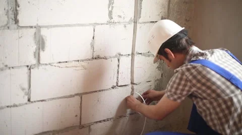 The man performs electrical installation work Video stock 61649906
