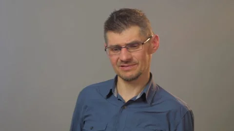 Man performs emotion of disgust and shows blurry tube Stock Footage 135390947