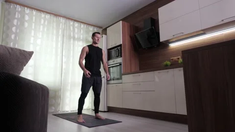 A man performs an endurance exercise in a home environment Video stock 135056394