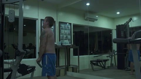 Man performs an exercise for biceps at the gym Video stock 91332218