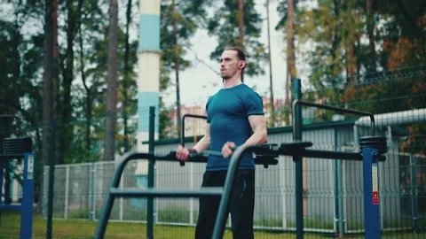 A man performs exercises on an open sports ground in the fresh air. Stock Footage 149752111