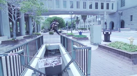 Man Performs Extreme Parkour Freerunning Flips Down Town in Slow Motion Stock Footage 50481726