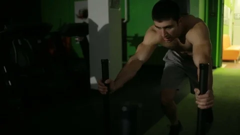 Man performs gym exercises. pushing the platform in front of him, powerlifting Stock Footage 70759579