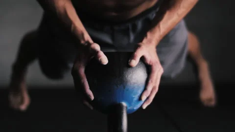 Man performs impressive push ups using a metal gym ball for core strength Stock Footage 312767378
