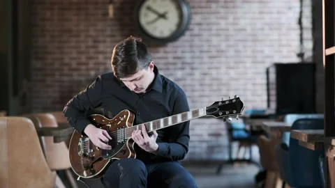 Man performs jazz, blues music on guitar in bar. Retro studio, brick interior Stock Footage 135355974