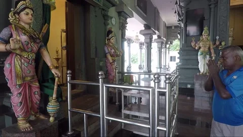 Man performs parikrama inside Hindu Temple, Batu caves, Kuala Lumpur, Malaysia Stock Footage 186580309