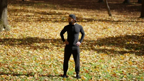 A man performs physical exercises in nature Stock Footage 230412242