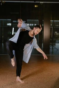 A man performs a randomized movement for yoga at a fitness gym Stock-Fotos