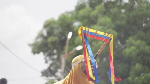 A man performs a traditional dance in a Dancing Devil costume in a small and 動画素材 312913539