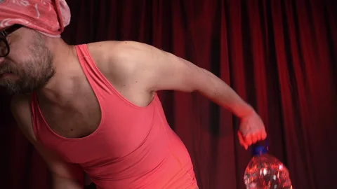 Man performs triceps exercise using a big bottle of water as a weight. Stock Footage 132952218