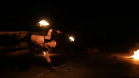 Man performs a trick with fire Stock Footage 71533779