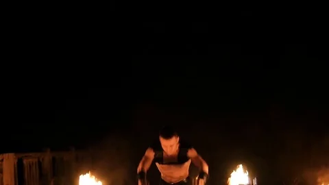 Man performs a trick with fire Stock Footage 71534483