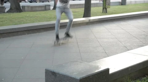 Man performs a trick on a skateboard in a roadside park. Stock Footage 51754832
