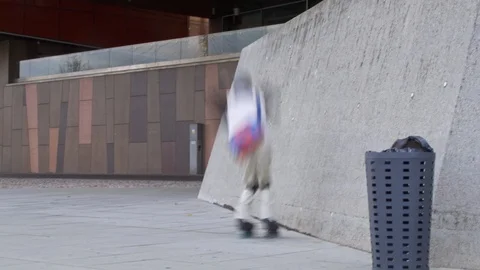 Man performs wall ride trick on inline skates in motion blur Stock Footage 119476460
