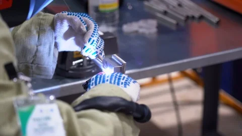 Man performs welding work with a semi-automatic machine close up view on factory Stock Footage 126356475