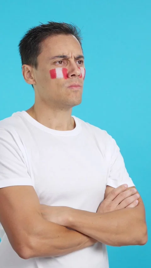 Man with peruvian flag painted looking away with serious expression Stock Footage 261400295
