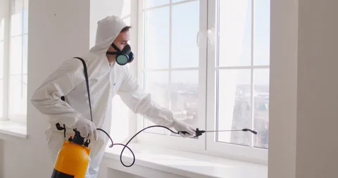 Man pest control worker spraying insecticide around house, eliminating bugs 스톡 동영상 311228880