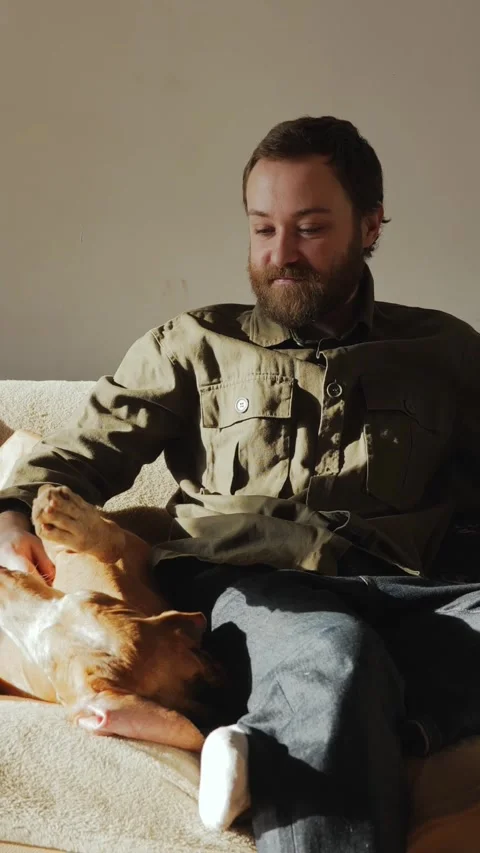 Man Petting His Dog on Sofa 스톡 동영상 320803538