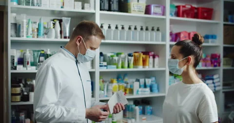 Man pharmacist verifies the data of medicines using a tablet. Job Stock Footage 145891212