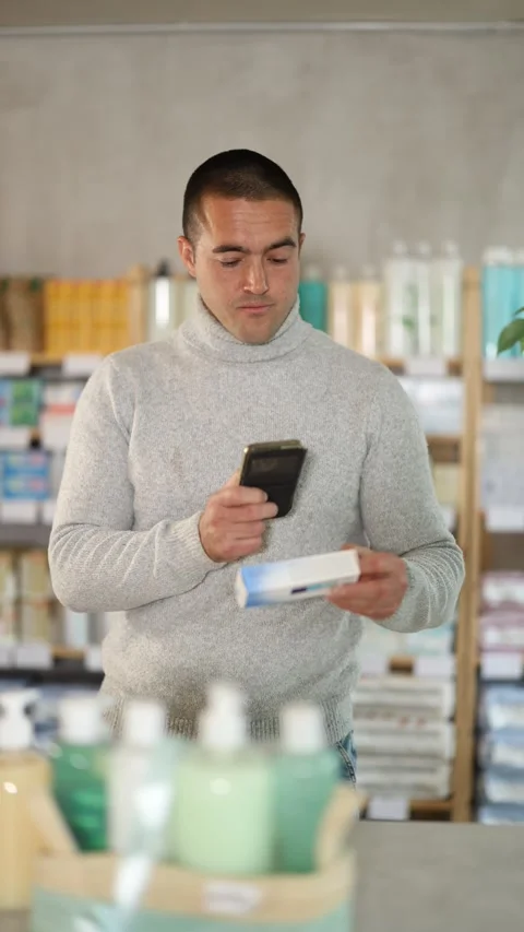 Man in pharmacy scans QR code on antifungal ointment product Stock Footage 317138306