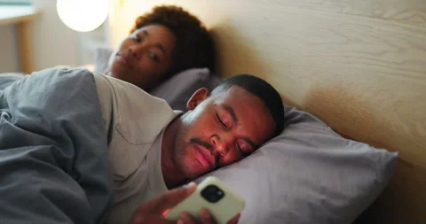 Man, phone and couple in bed with cheating, secret text message and unfaithful Stock Footage 337496801