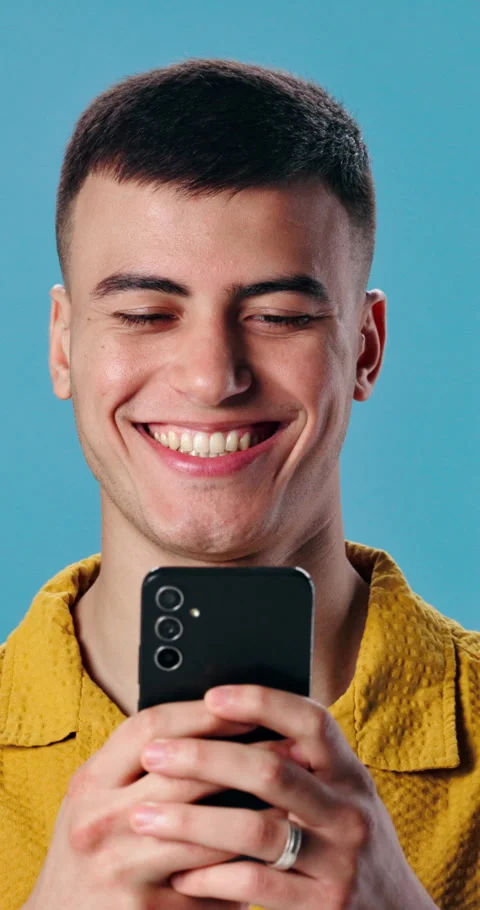 Man, phone and laugh in studio for social media humor, chatting or meme with Stock Footage 343047640