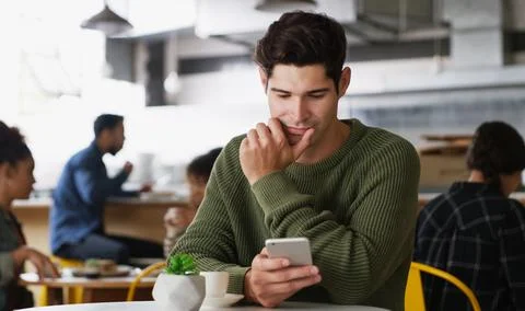 Man, phone and thinking at cafe with texting for online dating, chat or not.. Stock Photos