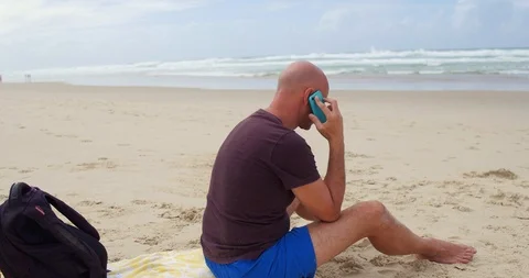 Man on the phone at the beach Stock Footage 87993475