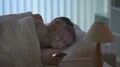 The man phone on the bed near the woman 4k or 4k+ Resolution